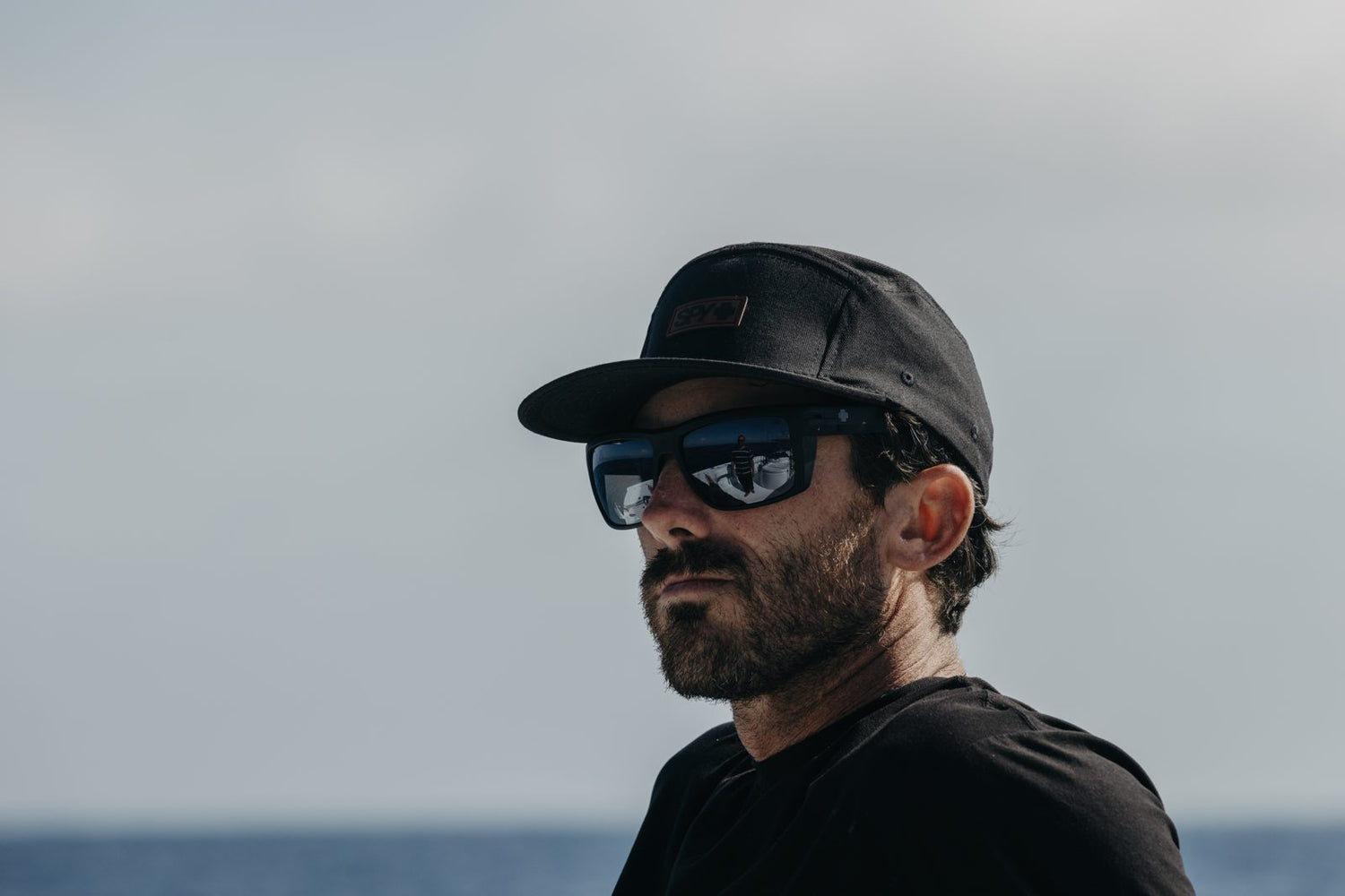 Man outdoors in mirrored polarized sunglasses