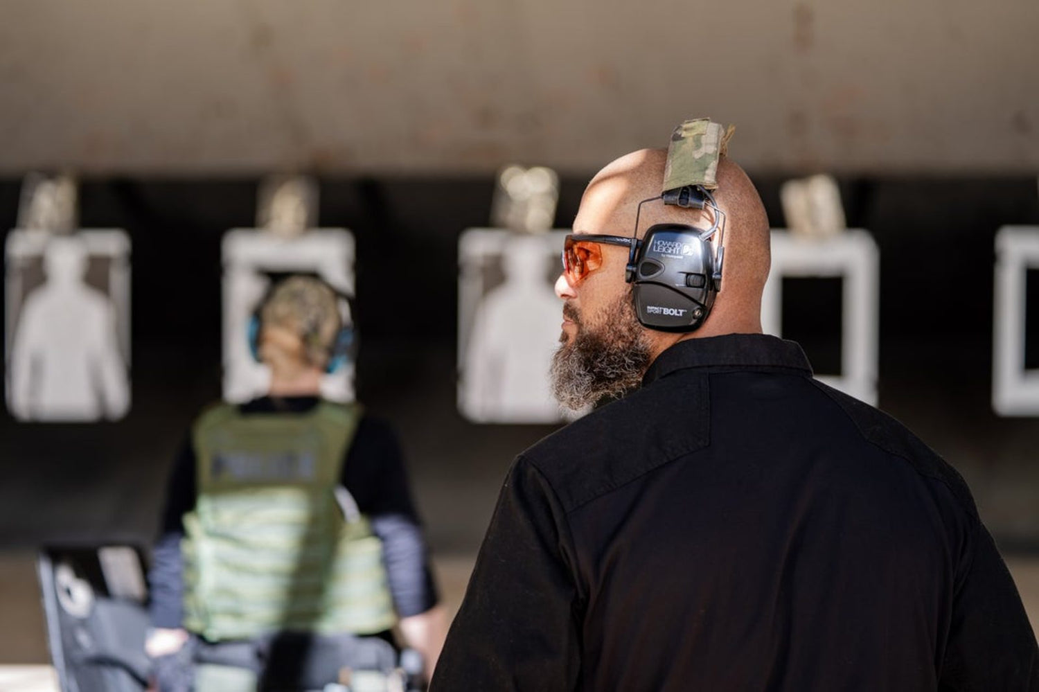 Shooter at an indoor range in eye and ear protection