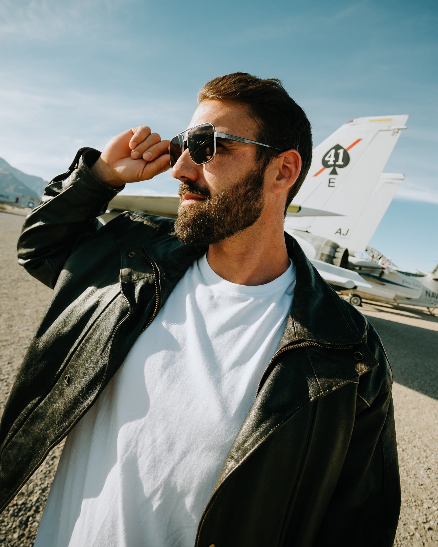 Man wearing Heat Wave Nimitz sunglasses at an airfield