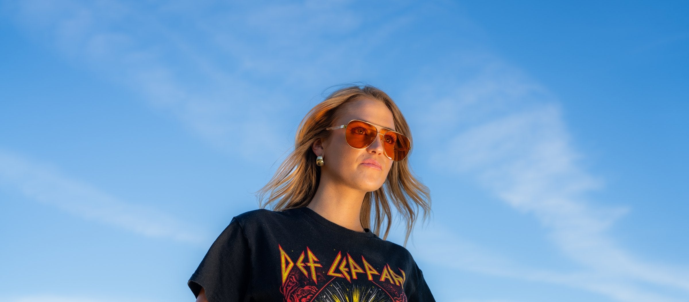 Woman wearing amber sunglasses outdoors