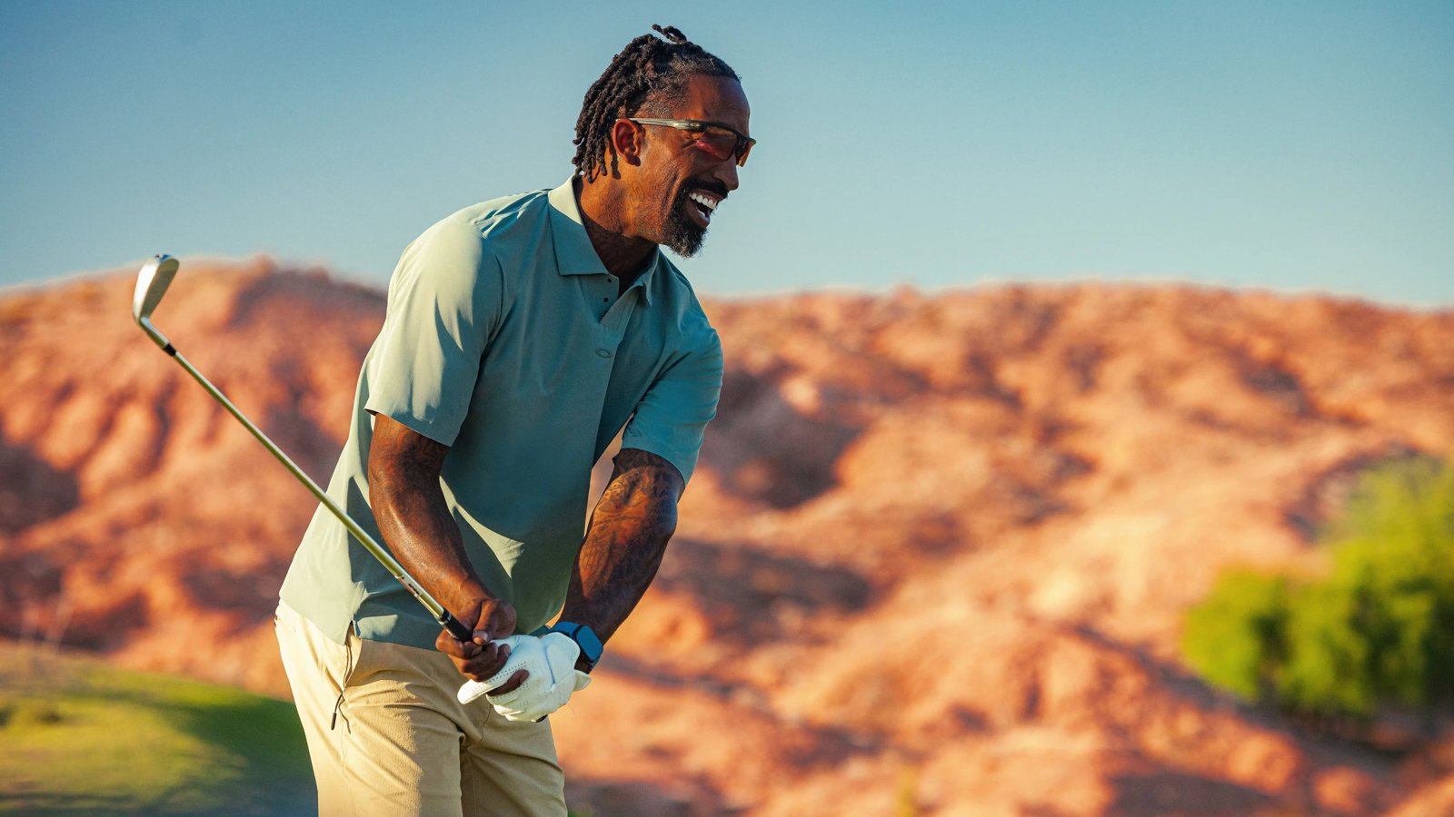 Golfer wearing performance eyewear in bright desert sunlight